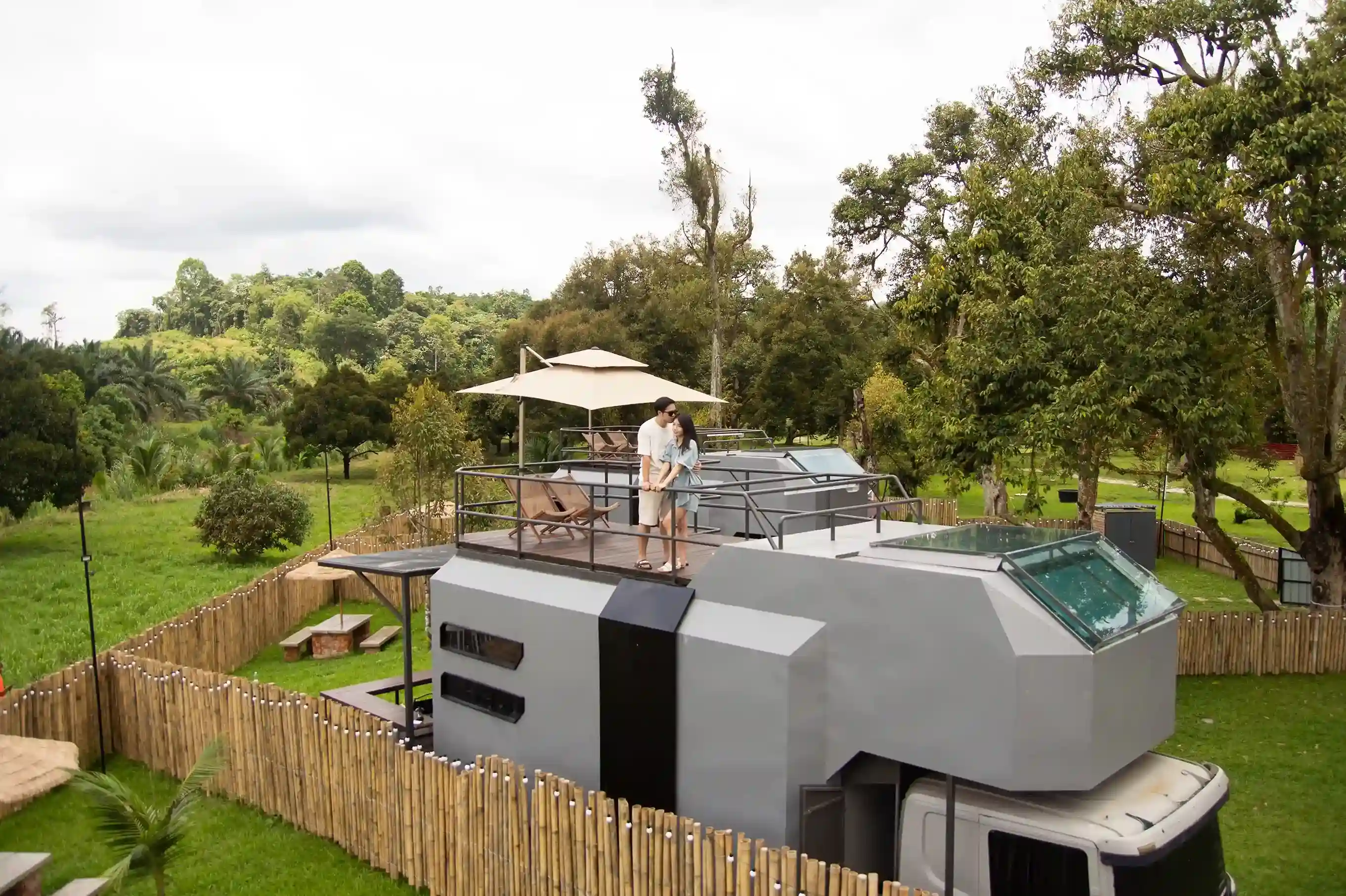 Couple at rooftop of Cybertruck suite at Suka Camping
